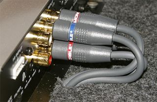 RCA cables routed through slits in the vehicles carpet, and connected 