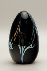 Sleek egg shaped design with iridescent silver swirls on black 