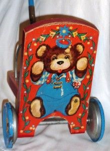 vintage push toy with teddy bear ringing bell