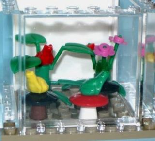 Aquarium comes with 3 different colored frogs and many plants.