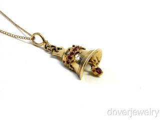 crafted in solid 9K yellow gold. This beautiful piece displays a bell 