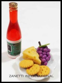  Miniature Crackers Cheese Grapes on A Plate Bottle of Wine Food