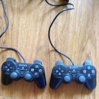 Two PlayStation DualShock 2 Controllers